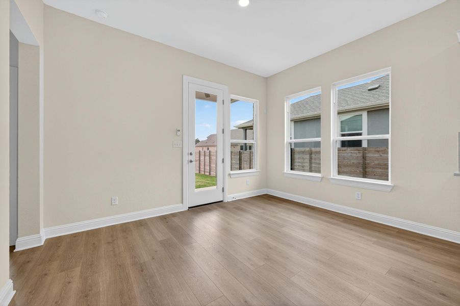 Unfurnished room featuring light wood-type flooring and baseboards
