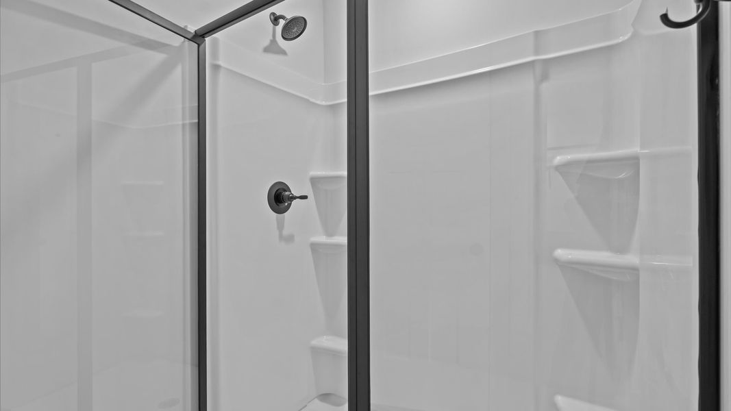 Exceptional en-suite with dual vanity and glass-enclosed walk-in shower for superior everyday comfort Exceptional en-suite with dual vanity and glass-enclosed walk-in shower for superior everyday comfort