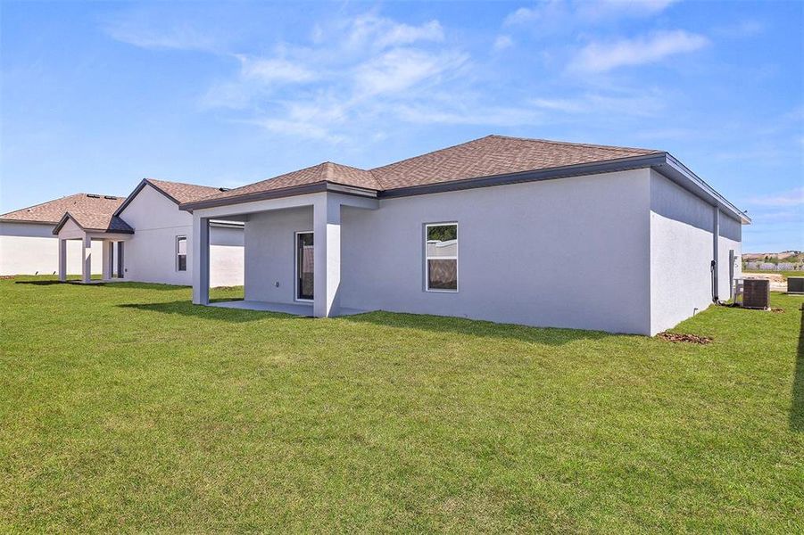 Front exterior of a new home in Peach Crossings, Winter Haven, FL, highlighting curb appeal (Image 2).