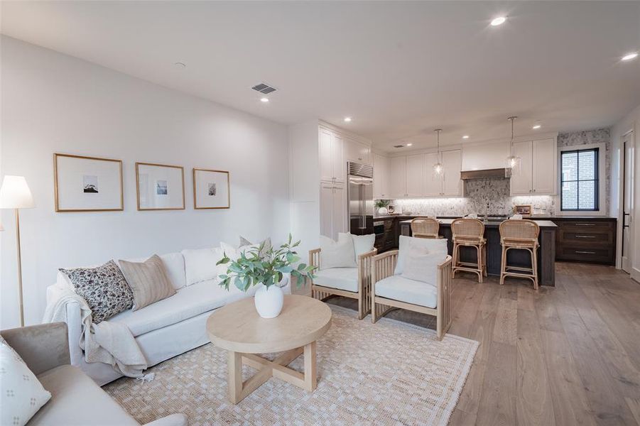 Living room with light hardwood / wood-style floors