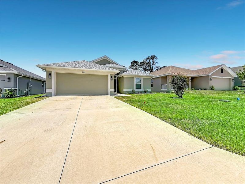 Front exterior of a new home in Twisted Oaks, Beverly Hills, FL, highlighting curb appeal (Image 21). Front exterior of a new home in Twisted Oaks, Beverly Hills, FL, highlighting curb appeal (Image 21).