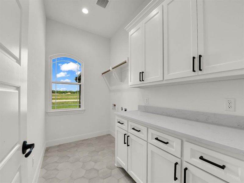 Washroom with cabinet space, washer hookup, recessed lighting, and baseboards