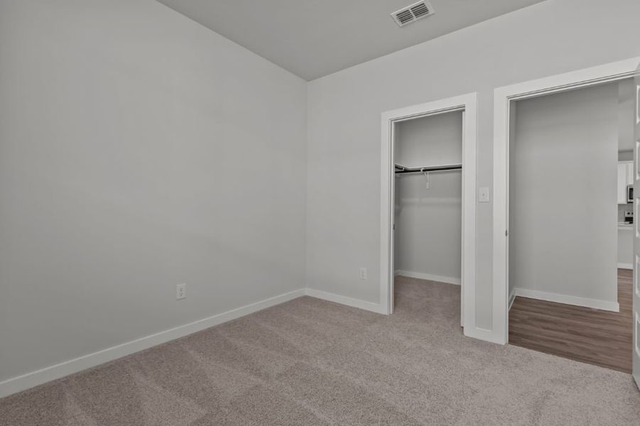 A room with a door and a mirror.