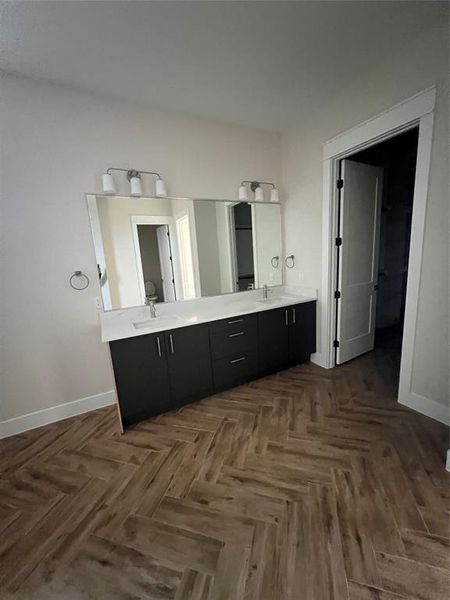 Bathroom featuring vanity and parquet flooring