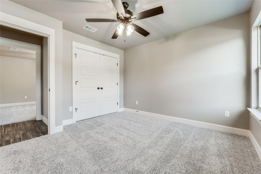 Unfurnished bedroom featuring carpet, a closet, and ceiling fan Unfurnished bedroom featuring carpet, a closet, and ceiling fan