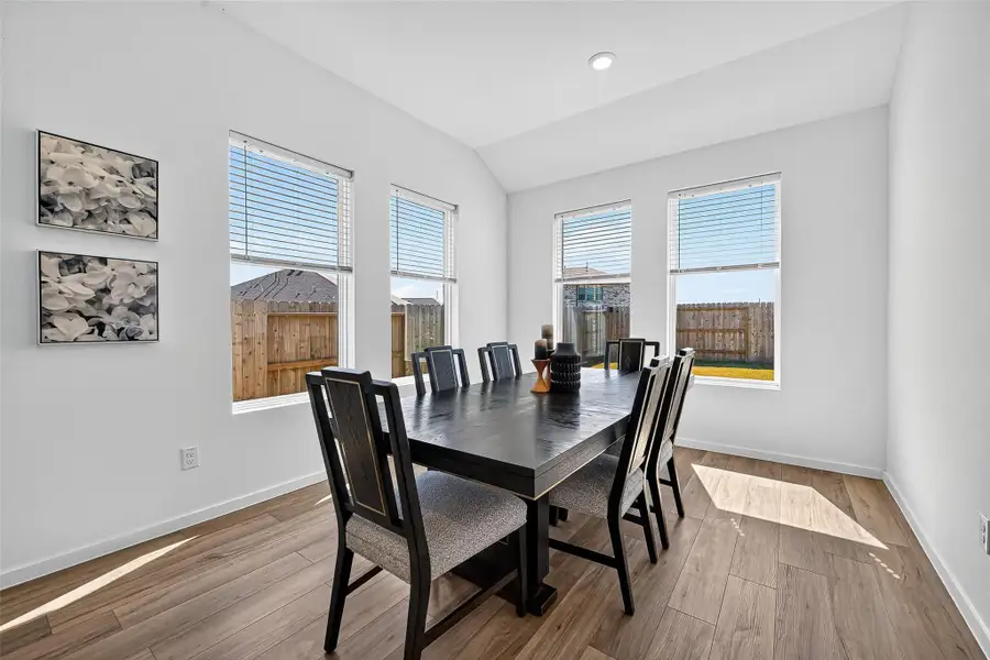 Sunlit dining area with a warm, welcoming atmosphere. Sunlit dining area with a warm, welcoming atmosphere.