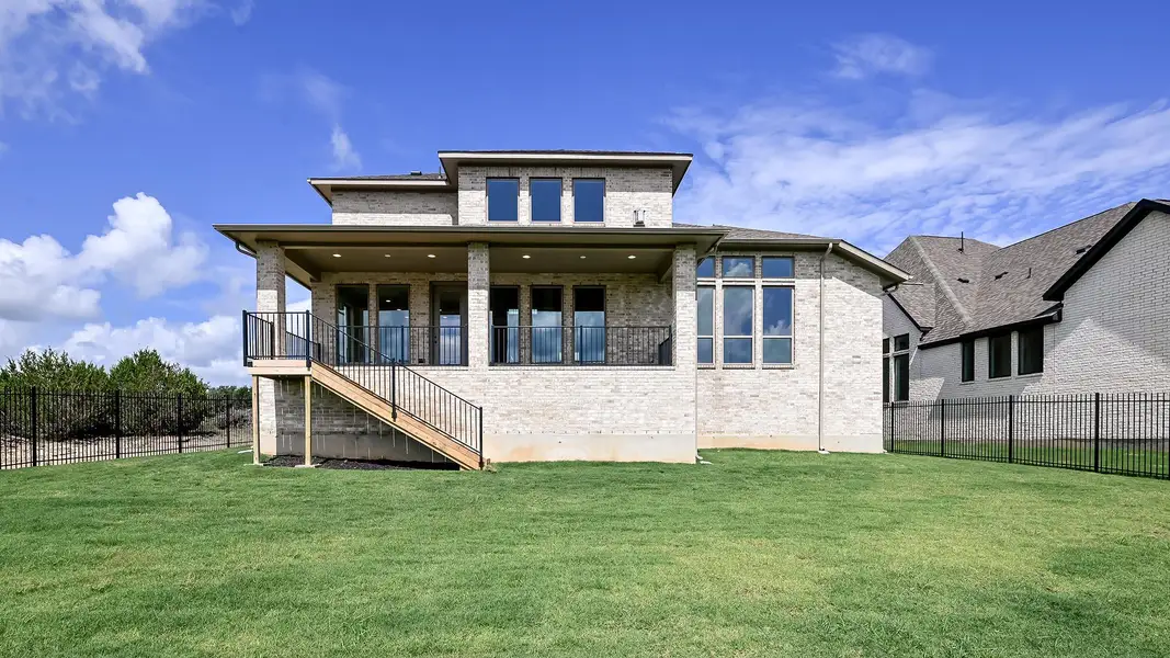 Rear view of house featuring brick siding and stairs Rear view of house featuring brick siding and stairs