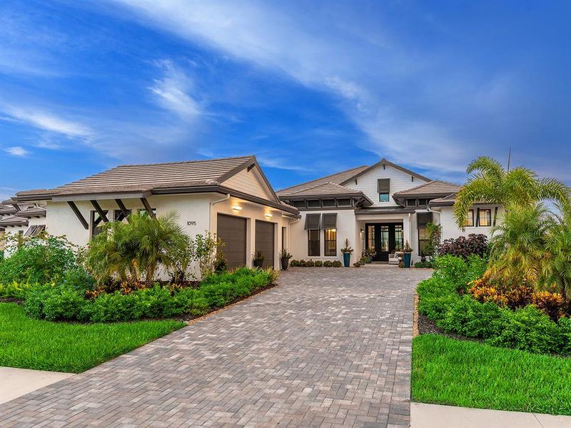 Front exterior of a new home in Wild Blue at Waterside, Sarasota, FL, highlighting curb appeal (Image 25). Front exterior of a new home in Wild Blue at Waterside, Sarasota, FL, highlighting curb appeal (Image 25).