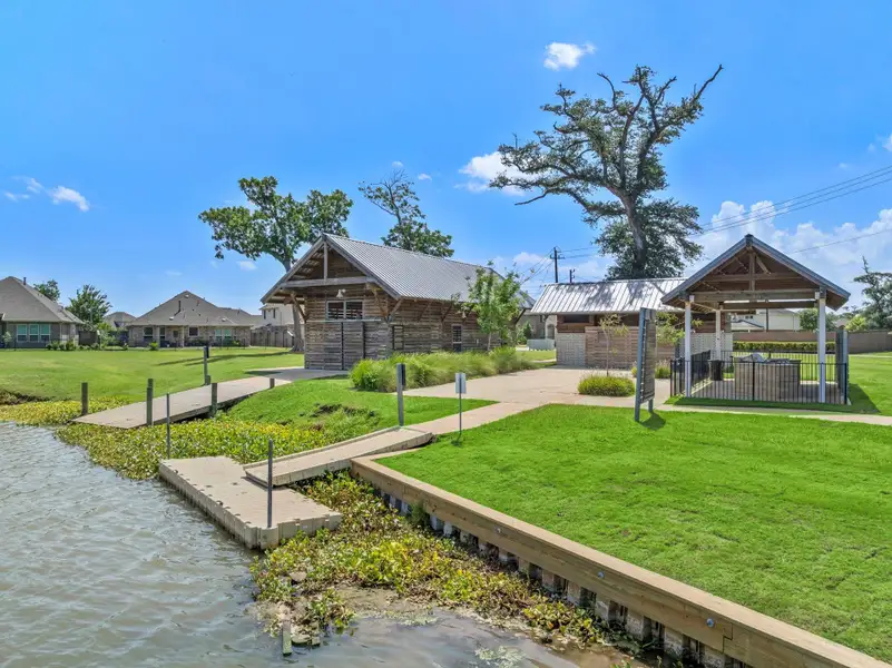 Front exterior of a new home in Woodshore, Clute, TX, highlighting curb appeal (Image 1).