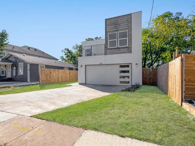 Contemporary home with a garage and a front yard