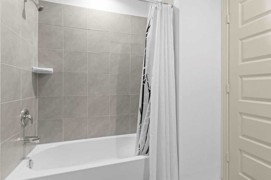 Tub and shower combination with tile surround and built-in shelving. Wait till you see this home! 2 1/2 bathrooms! Tub and shower combination with tile surround and built-in shelving. Wait till you see this home! 2 1/2 bathrooms!