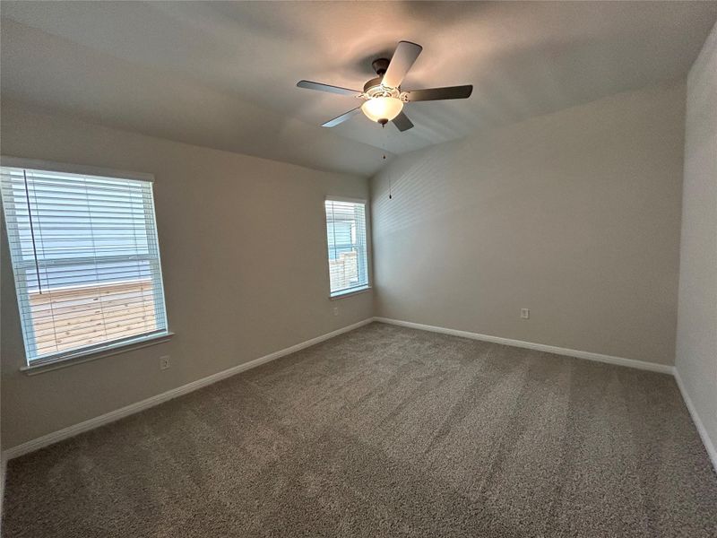 Empty room with carpet flooring and ceiling fan Empty room with carpet flooring and ceiling fan