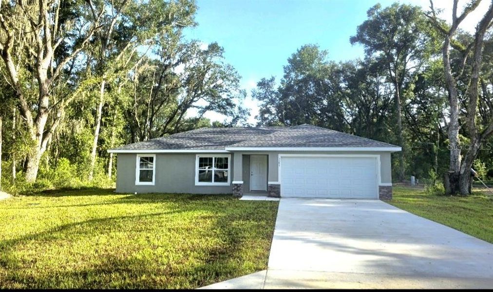 Front exterior of a new home in , Dunnellon, FL, highlighting curb appeal (Image 1).