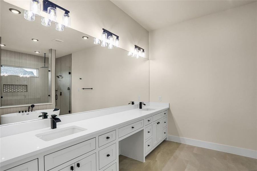 Bathroom featuring double vanity, a tile shower, recessed lighting, and tile patterned floors Bathroom featuring double vanity, a tile shower, recessed lighting, and tile patterned floors