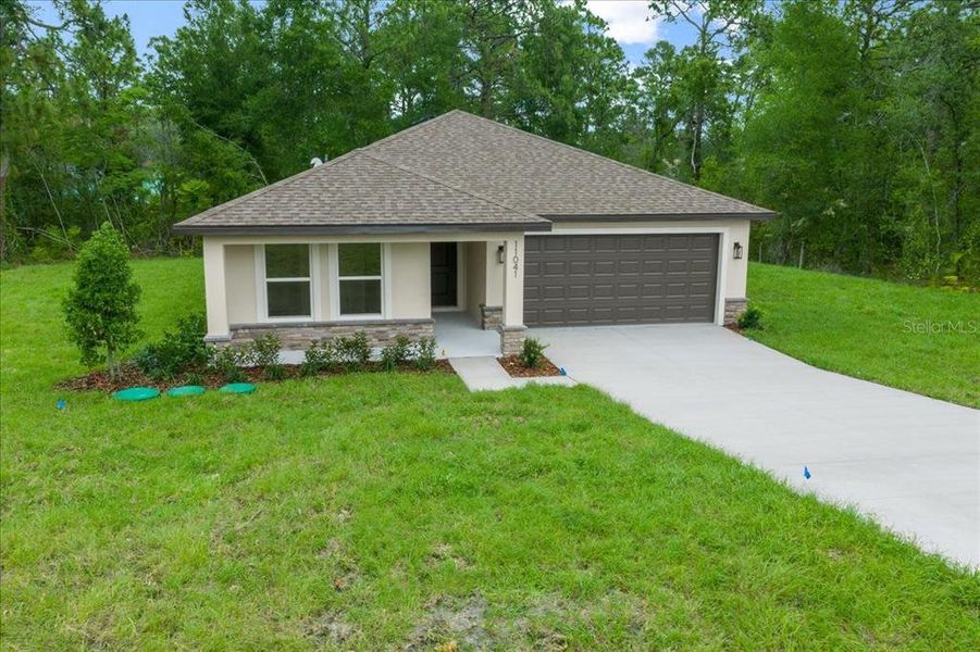 Front exterior of a new home in , Weeki Wachee, FL, highlighting curb appeal (Image 23).