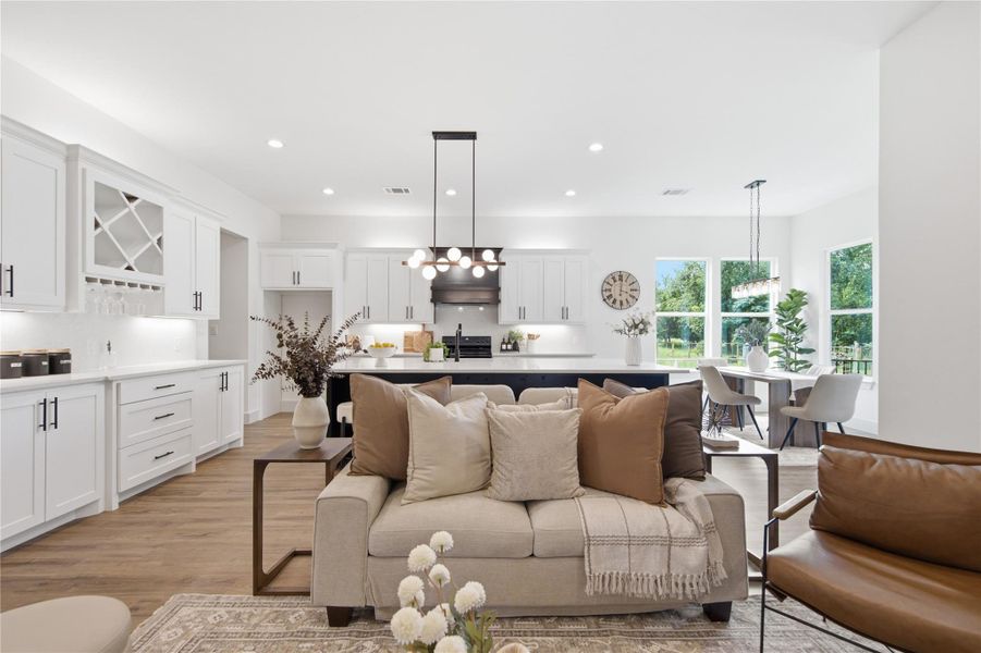 An open concept living area boasts a modern kitchen with a large island and ample natural light. An open concept living area boasts a modern kitchen with a large island and ample natural light.