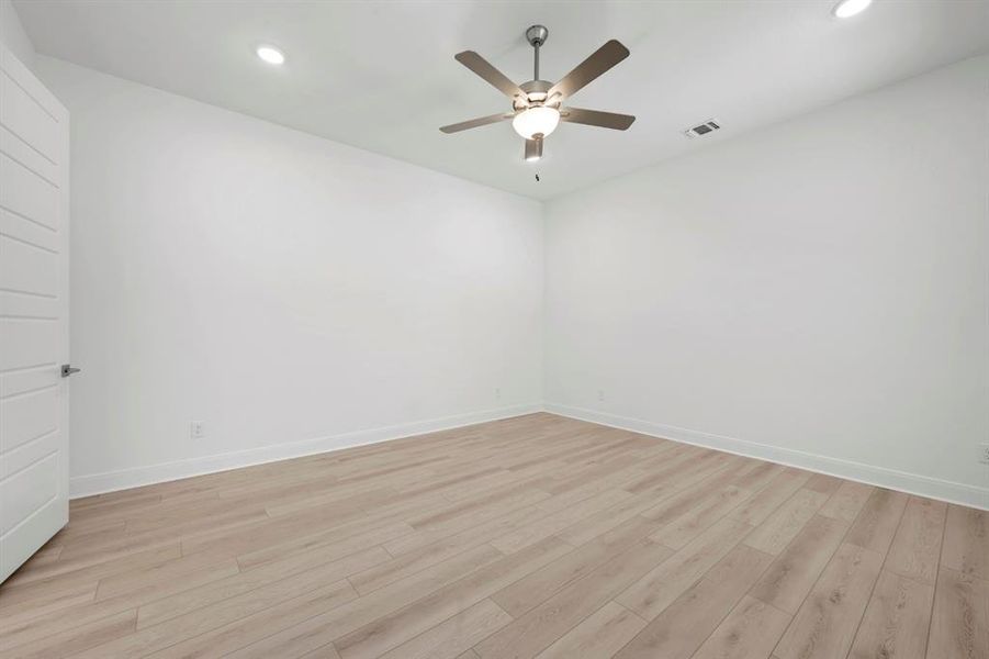 Unfurnished room with recessed lighting, a ceiling fan, and light wood-type flooring Unfurnished room with recessed lighting, a ceiling fan, and light wood-type flooring