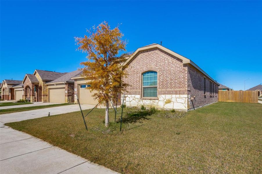 View of front of home with a garage and a front yard