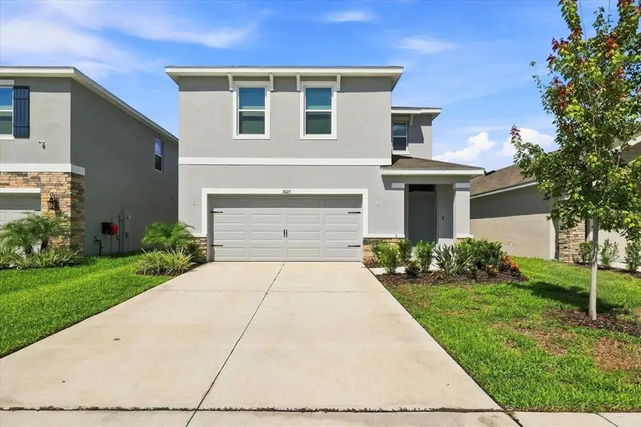 Front exterior of a new home in Deerbrook, Land O' Lakes, FL, highlighting curb appeal (Image 1). Front exterior of a new home in Deerbrook, Land O' Lakes, FL, highlighting curb appeal (Image 1).