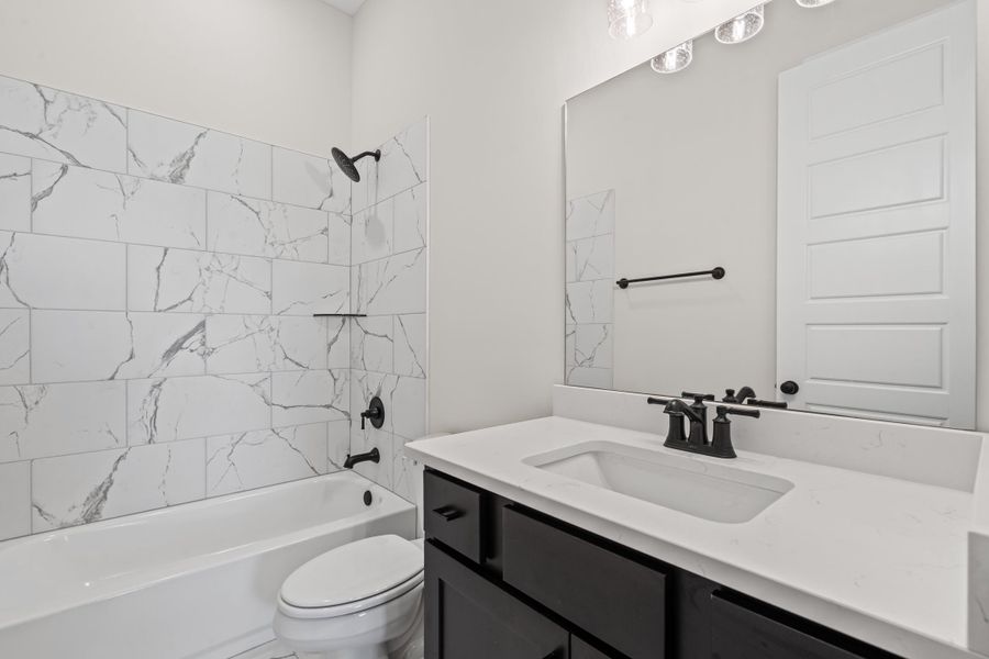 Bathroom featuring bathing tub / shower combination and vanity Bathroom featuring bathing tub / shower combination and vanity