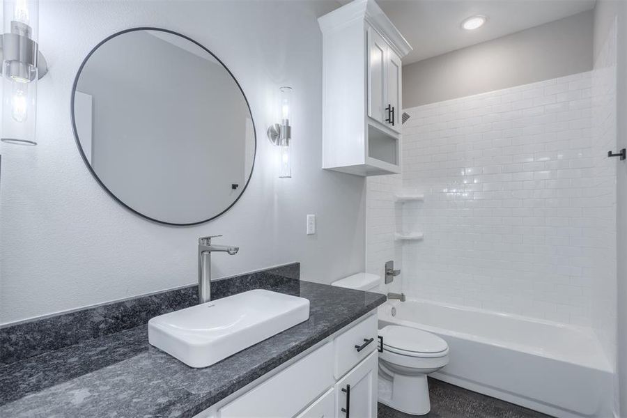 Bathroom featuring shower / bathtub combination and vanity Bathroom featuring shower / bathtub combination and vanity