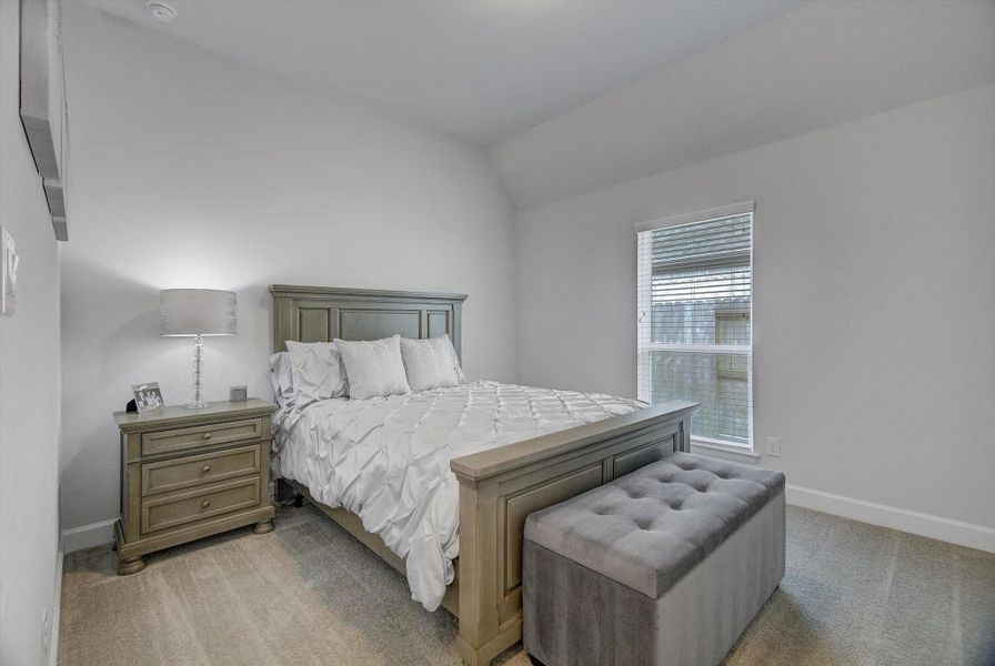 The spacious 12' x 13' third bedroom includes comfortable carpeting and a high-ceiling closet, creating an airy feel and excellent storage potential.