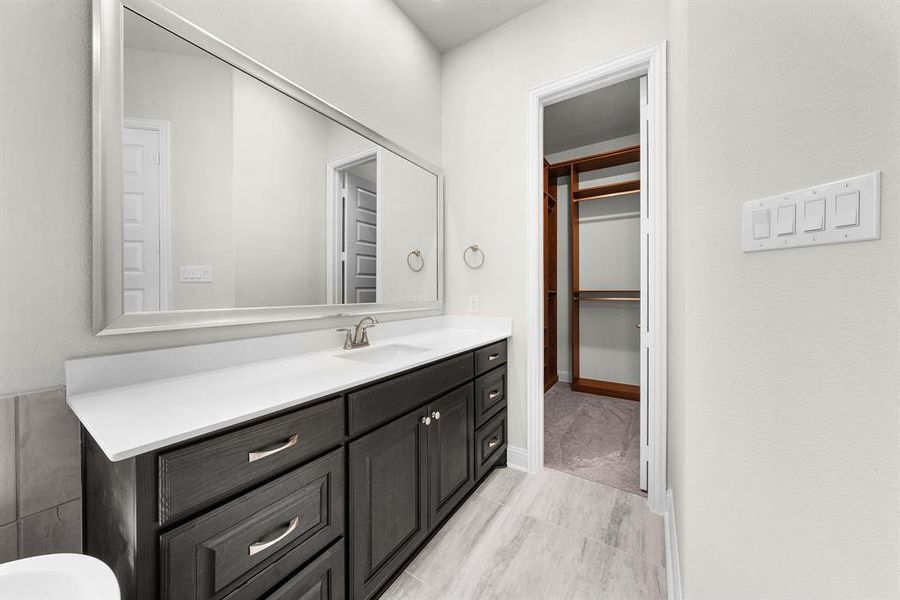 Bathroom featuring vanity and baseboards Bathroom featuring vanity and baseboards