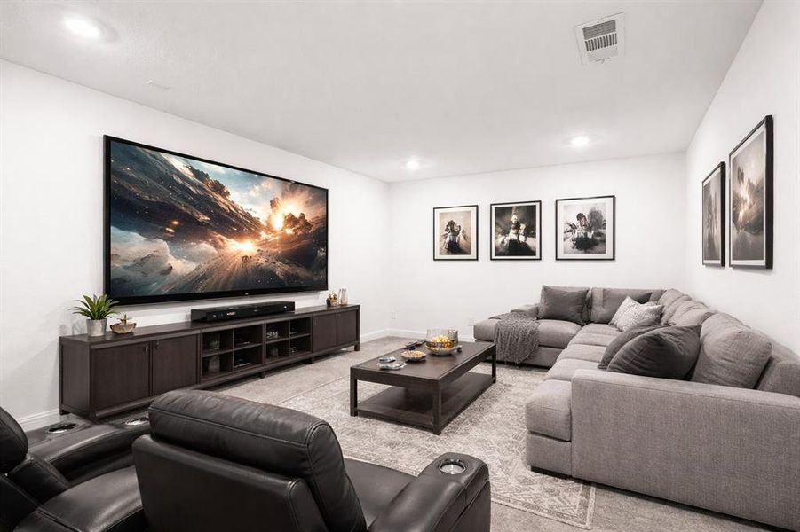 Carpeted living room with baseboards and recessed lighting