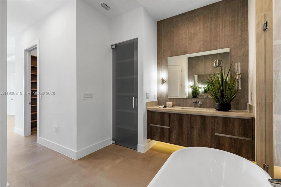 The primary bathroom includes a dedicated linen closet, providing convenient storage for towels and essentials.