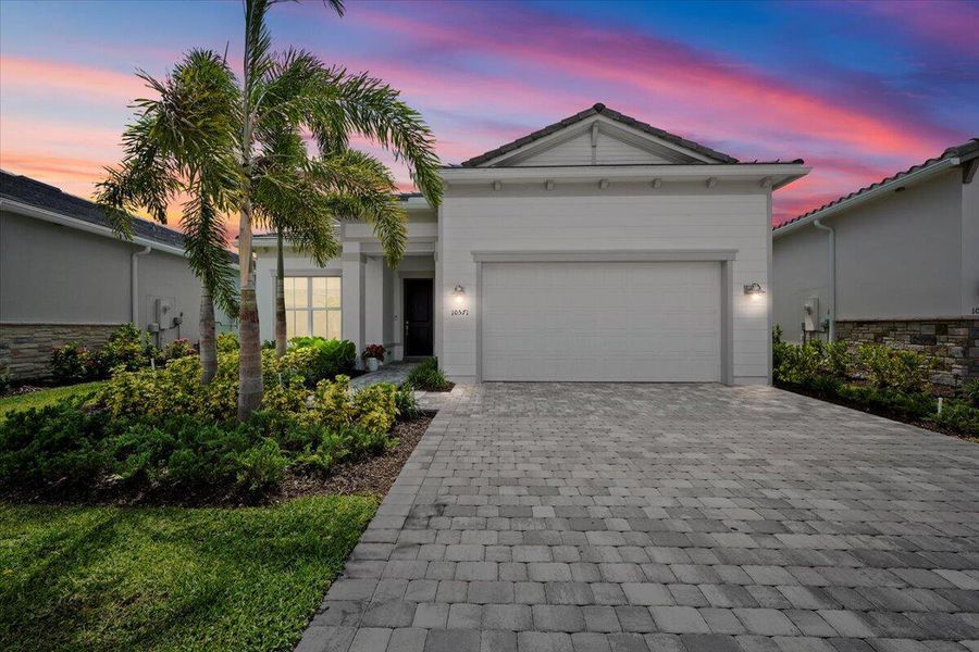 Front exterior of a new home in Avondale at Avenir, Palm Beach Gardens, FL, highlighting curb appeal (Image 18).