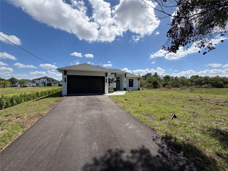 Front exterior of a new home in , Naples, FL, highlighting curb appeal (Image 20). Front exterior of a new home in , Naples, FL, highlighting curb appeal (Image 20).