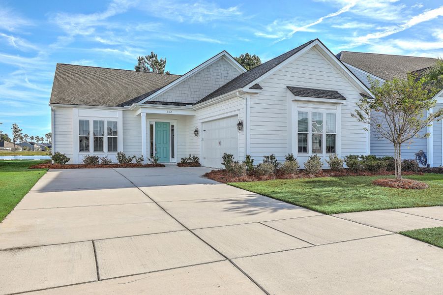 Front exterior of a new home in K. Hovnanian's® Four Seasons at Lakes of Cane Bay, Summerville, SC, highlighting curb appeal (Image 2).