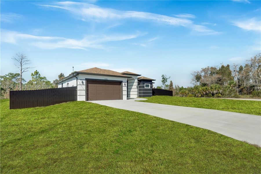 Front exterior of a new home in , Lehigh Acres, FL, highlighting curb appeal (Image 23).