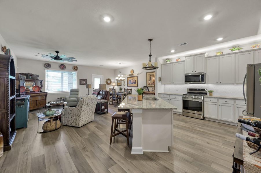 Bright and spacious open-concept layout seamlessly connects the kitchen, dining, and living areas, creating the perfect space for everyday living, entertaining guests, and gathering with family and friends. Bright and spacious open-concept layout seamlessly connects the kitchen, dining, and living areas, creating the perfect space for everyday living, entertaining guests, and gathering with family and friends.