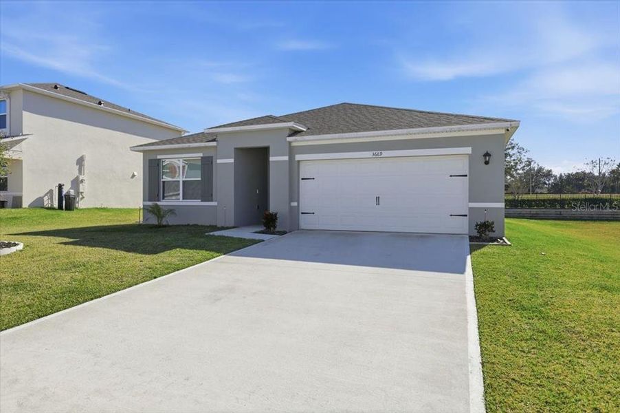 Front exterior of a new home in Oak Pointe, Apopka, FL, highlighting curb appeal (Image 2). Front exterior of a new home in Oak Pointe, Apopka, FL, highlighting curb appeal (Image 2).