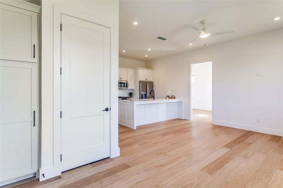 Kitchen with recessed lighting, white cabinetry, light wood-style flooring, appliances with stainless steel finishes, and a ceiling fan
