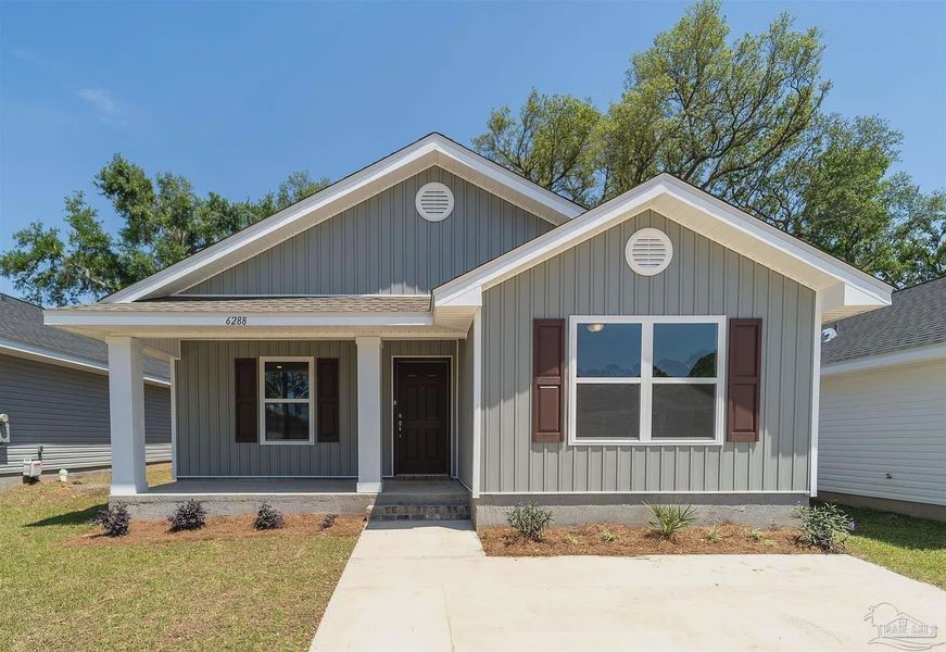 Front exterior of a new home in Turtle Creek, Cantonment, FL, highlighting curb appeal (Image 1).