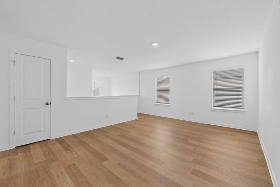Empty room featuring light wood-style flooring and recessed lighting