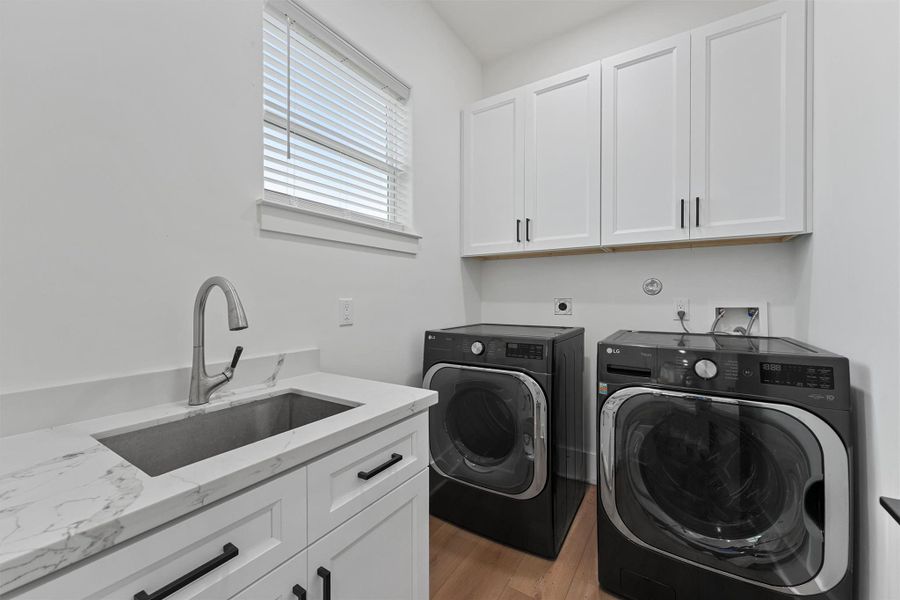 Convenient main-level laundry room with LG washer/dryer, abundant storage, and a handwashing sink. Convenient main-level laundry room with LG washer/dryer, abundant storage, and a handwashing sink.