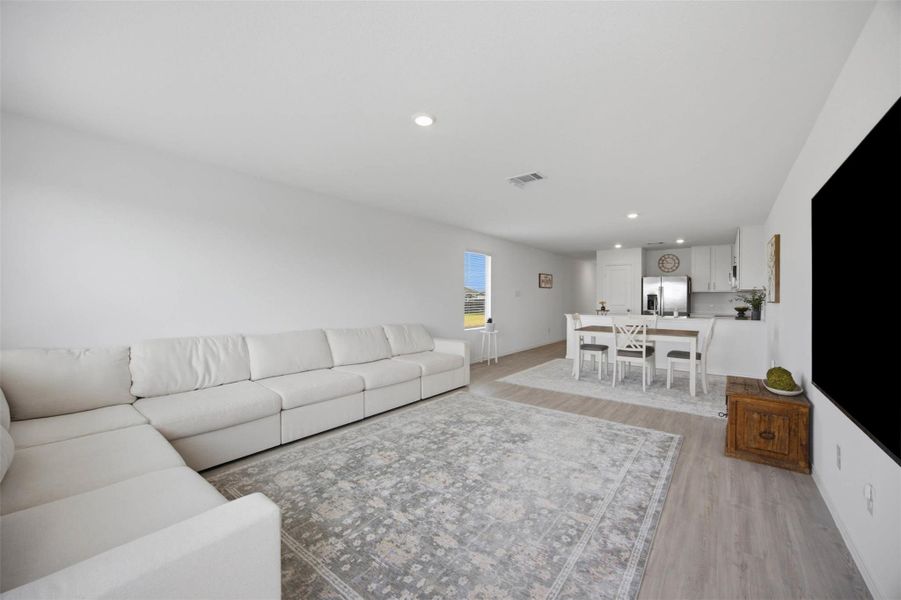 An open layout connects the spacious living room directly to the dining area.