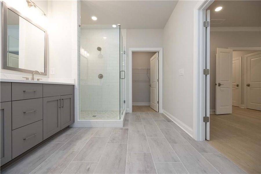 The closet is located off of the primary bathroom. *Please note photos shown are of the Ellington plan but not of the actual home.