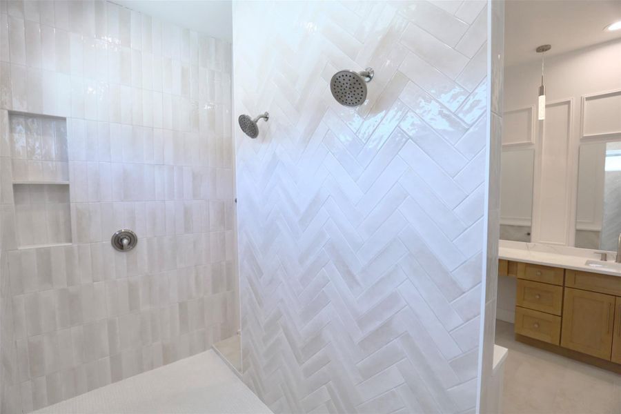 Trim valves thoughtfully placed on the shower wall sides, away from the showerheads, for clean aesthetics.Custom mitered-edge niche provides elegant storage for shower essentials. Trim valves thoughtfully placed on the shower wall sides, away from the showerheads, for clean aesthetics.Custom mitered-edge niche provides elegant storage for shower essentials.