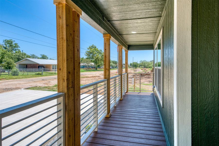 A welcoming front porch features sturdy wooden posts and sleek metal railings. A welcoming front porch features sturdy wooden posts and sleek metal railings.