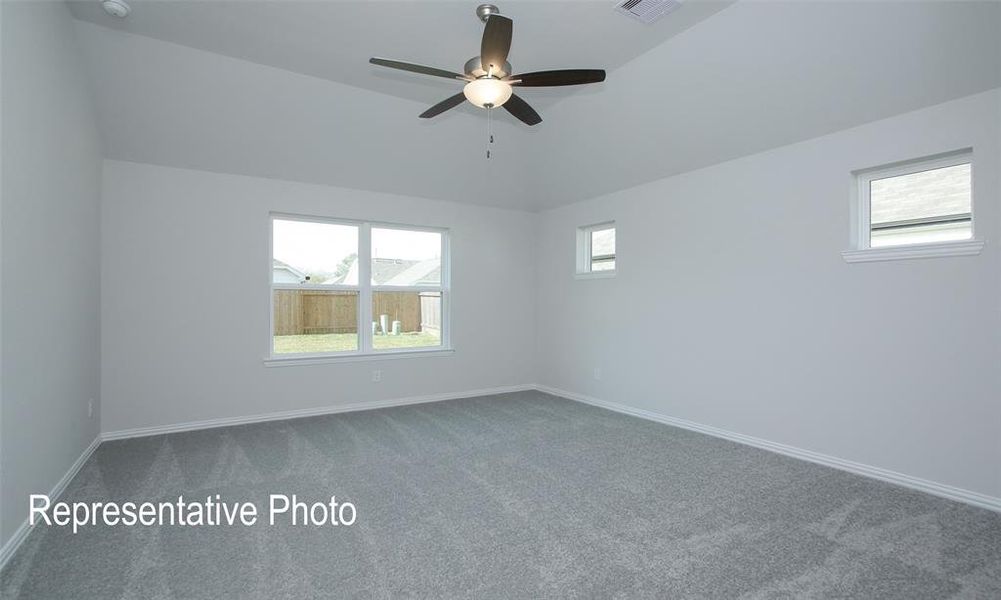 Carpeted empty room featuring ceiling fan