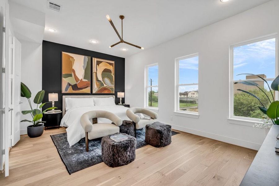 Similar plan and finishes minus the accent wall.  Love the large windows in this Primary bedroom and view of Downtown.