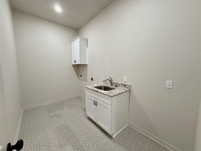 Laundry area featuring washer hookup and cabinet space