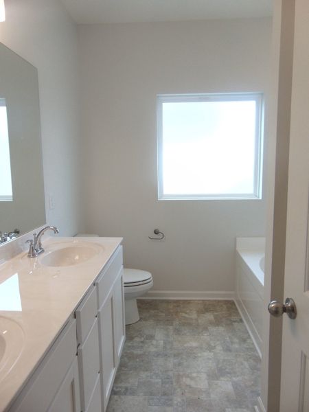 The primary bathroom comes with a two sink, soaking bath tub, shower, and an elongated toilet. The primary bathroom comes with a two sink, soaking bath tub, shower, and an elongated toilet.