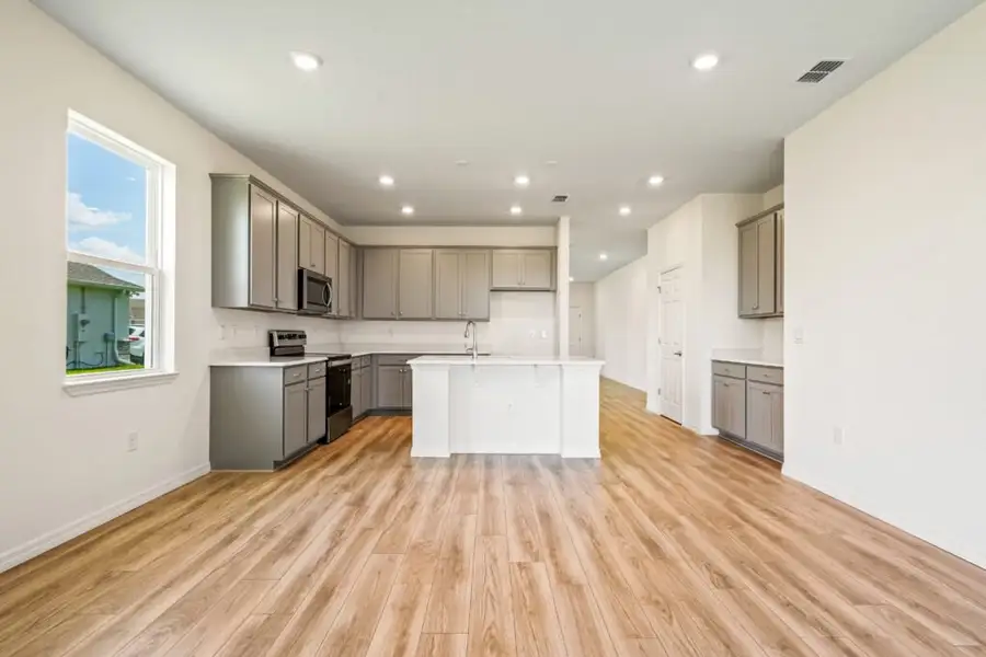 Representative furnished interior of a home built from the Jensen by Holiday Builders in Pineapple Grove, Port St. Lucie (Image 4).