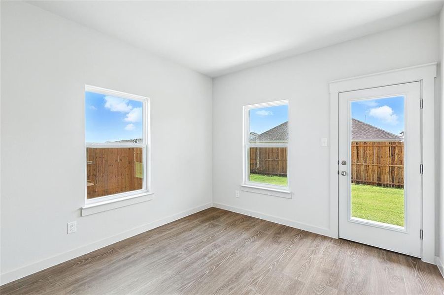 Spare room with light wood-style floors and baseboards Spare room with light wood-style floors and baseboards