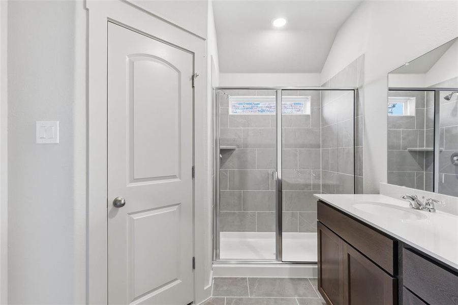 Full bathroom with vanity and a stall shower